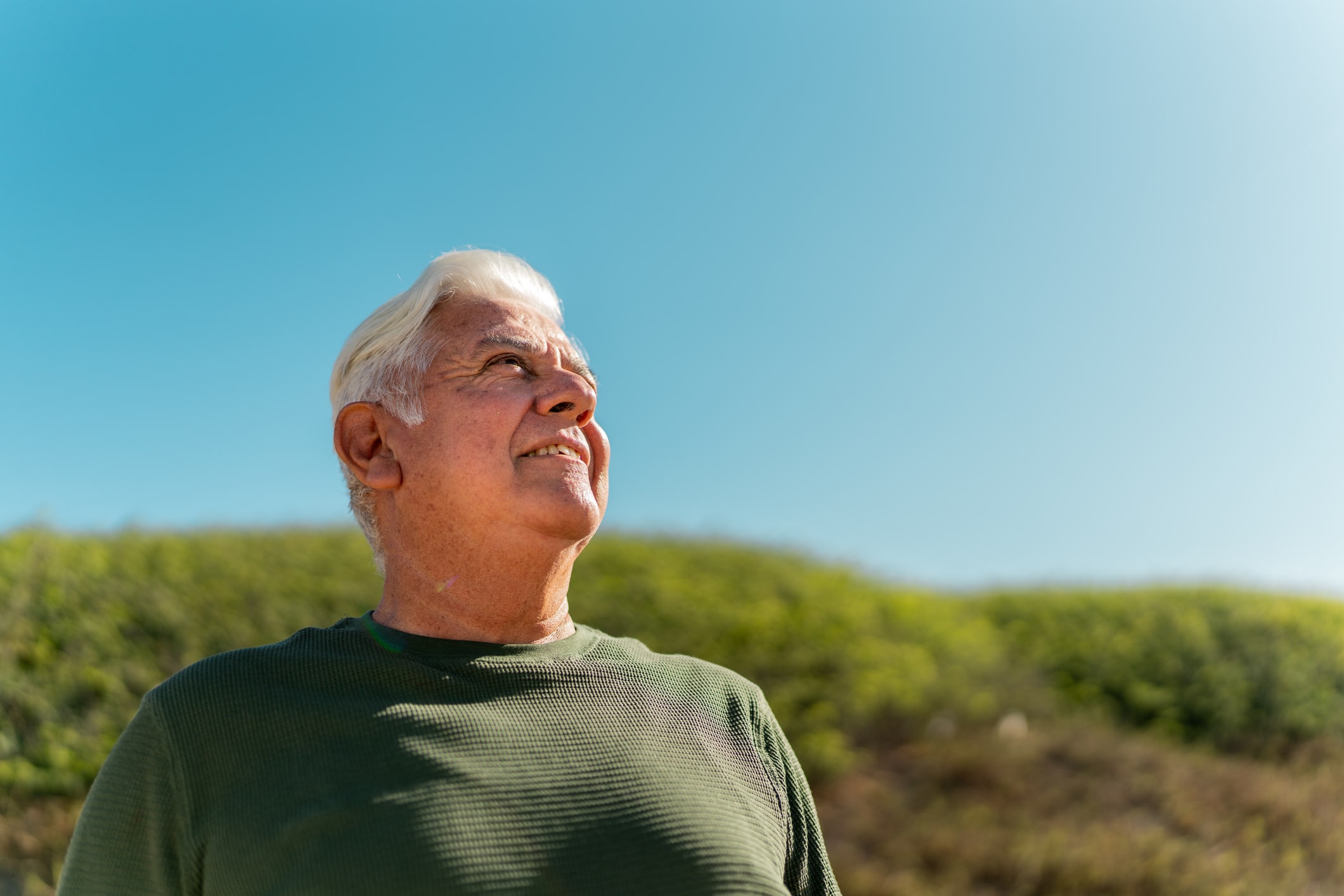 Senior man looking away contemplating outdoors