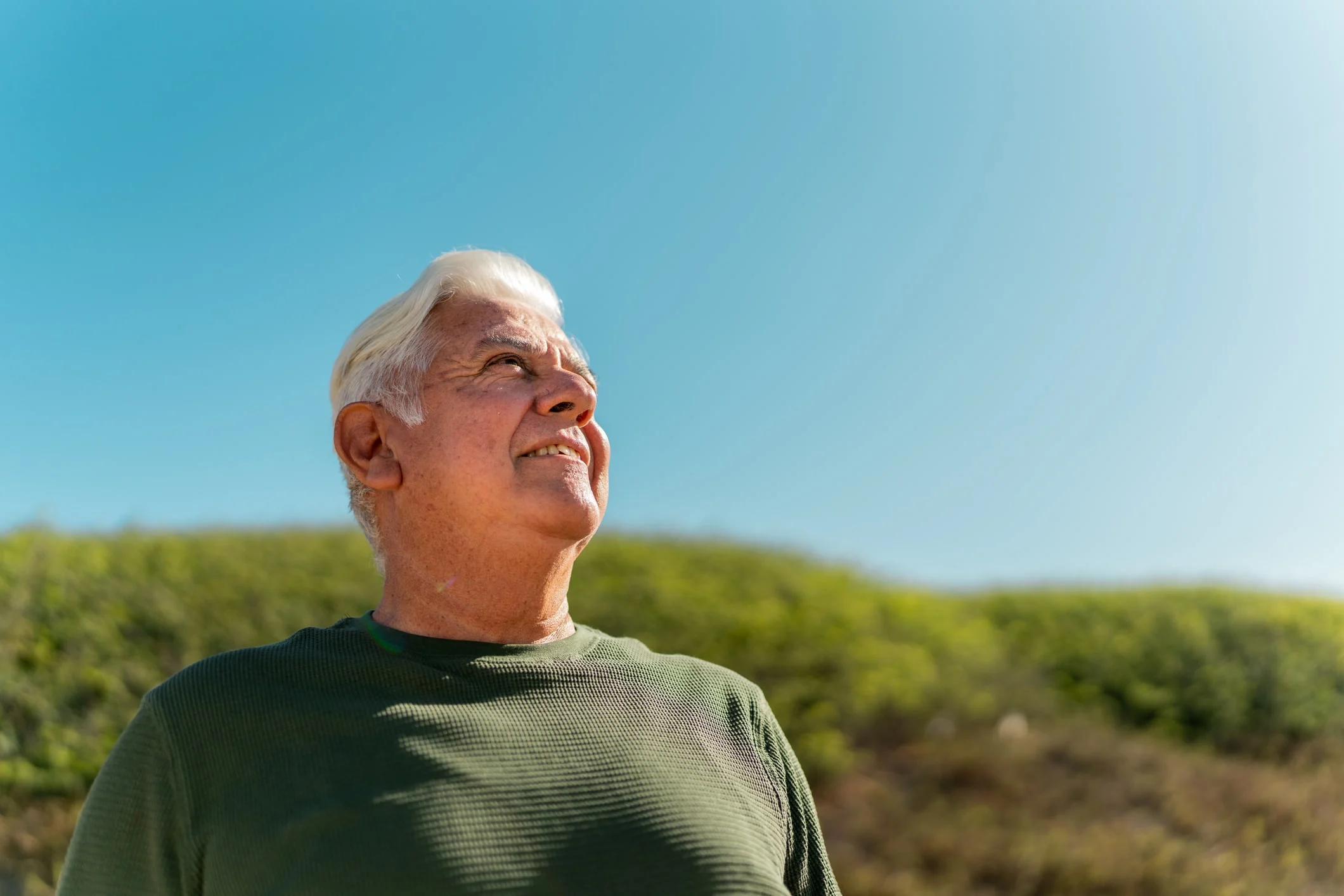 Senior man looking away contemplating outdoors
